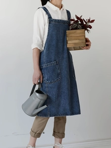 Women's dark blue denim pinafore dress with adjustable straps and front pockets