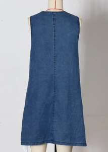 Detail view of the back of a blue denim sleeveless dress with vertical stitching