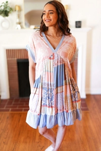 Detail of patchwork summer dress with V-neck, floral patterns, and ruffled hem design