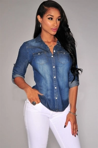 Detail of vintage blue wash denim shirt with chest pockets and distressed metal buttons