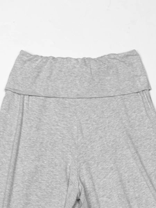 Close-up of heather grey knit shorts featuring a wide fold-over elastic waistband