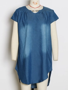 Detail of dark blue washed denim dress featuring pleated crew neck and irregular hemline