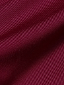 Macro shot of glossy burgundy silk-like ribbed fabric texture for sexy jumpsuits
