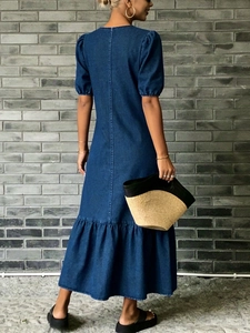 Détail de la vue arrière d'une robe en denim bleu avec manches bouffantes et volants