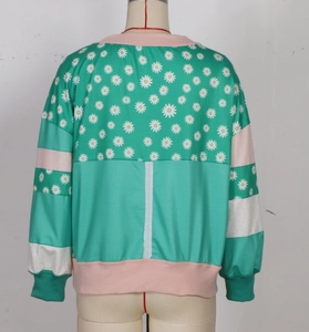 Close-up of mint green mint striped sweatshirt with daisy floral print on the back