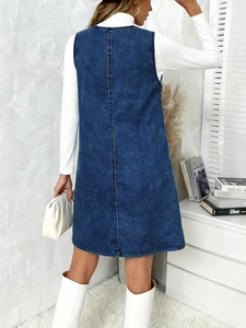 Deep blue denim pinafore mini dress with back seam detail shown on model from behind