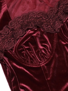 Macro shot of burgundy velvet top featuring delicate lace trim and mesh stitching details