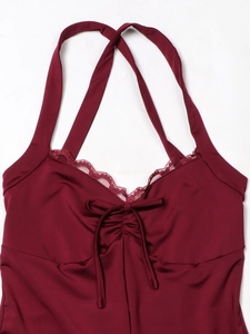 Close-up of burgundy satin bodysuit with V-neck lace trim and delicate bow detail