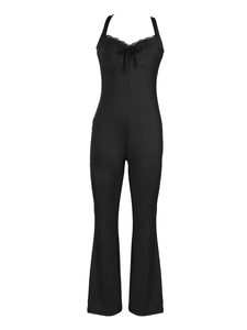 Detail of black jumpsuit with lace V-neckline, bow drawstring, and flared pants