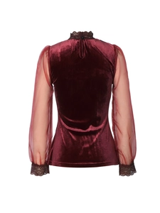 Detail view of burgundy velvet top back featuring sheer mesh sleeves and lace trim