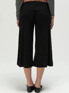 Rear view of black high-waisted wide-leg culottes with a soft draped fabric texture