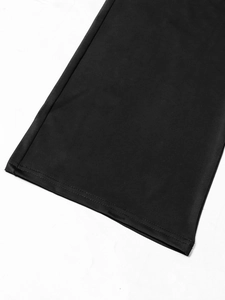 Detailed close-up of double-needle stitching and fabric texture on black jumpsuit hem