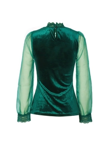 Detail of elegant velvet top with sheer mesh sleeves and delicate lace cuffs