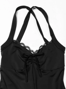 Detailed close-up of black V-neck jumpsuit with delicate lace trim and ribbon bow detail