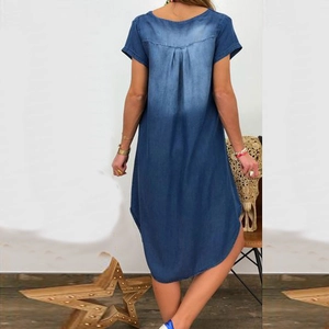 Rear view detail of casual denim dress showing pleated back and washed blue fabric texture