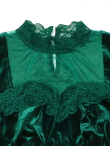 Detail of dark green velvet top with sheer lace sleeves and back button closure