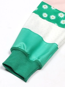 Detail of multi-color patchwork sleeve with daisy print and ribbed cuffs on sweatshirt