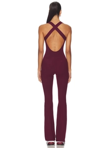 Burgundy v-neck jumpsuit for women featuring criss-cross back and flared leg trousers