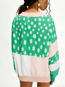 Women's color block sweatshirt with daisy print and pink ribbed cuffs and hem