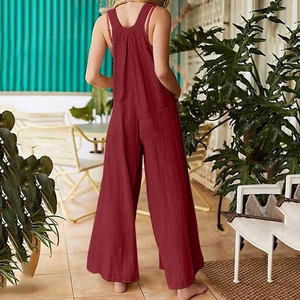 Detail view of wine red loose sleeveless jumpsuit featuring side pockets and back straps
