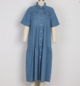 Dettaglio dell'abito lungo in denim con bottoni, colletto a camicia e gonna a balze