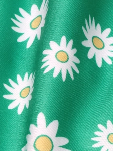 Macro view of bright green knit fabric with white daisy floral print and fine twill texture