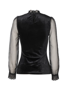 Detailed back view of a black velvet top featuring sheer mesh sleeves and lace trim detail