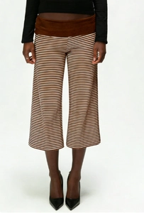 Detail of wide-leg cropped pants featuring brown stripes and a wide solid waistband