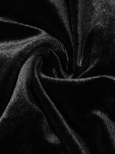Close-up of black ribbed velvet fabric showing luxurious vertical stripe texture