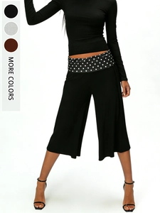 Detail of wide-leg trousers featuring a chic polka dot waistband and multi-color options