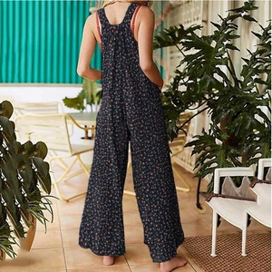 Floral print wide-leg overalls for women featuring side pockets and back straps in outdoor setting
