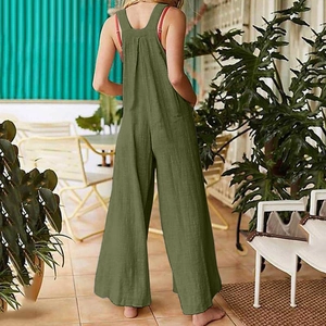 Back view of loose grass green cotton linen jumpsuit with wide legs and racerback style