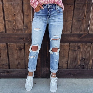 Women's light blue distressed ripped denim jeans with street style frayed hems