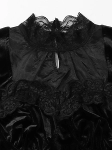 Close-up of black velvet top featuring lace collar and teardrop cutout detail