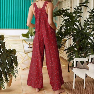 Close-up of red floral wide-leg jumpsuit showing open back design and relaxed fit style