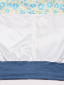 Close-up of floral print fabric combined with white cotton and navy ribbed knit cuffs