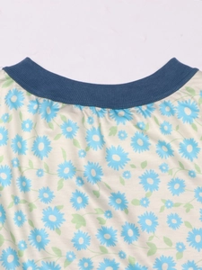 Detail of blue ribbed crew neck and daisy floral print on casual long sleeve knit top