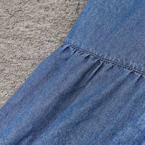 Dettaglio macro del tessuto denim blu con trama a saia e trama a pieghe arricciate