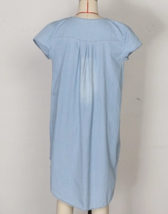 Detail view of the light blue chambray dress back with yoke and box pleat design
