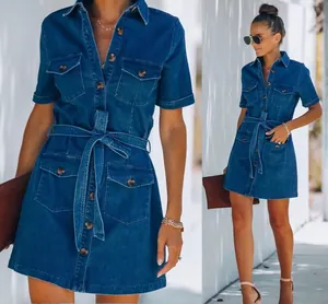 Detailed view of deep blue denim dress featuring utility pockets and a waist tie belt