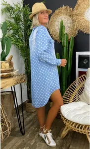 Detail view of a blue star print shirt dress with a stylish high-low hem design