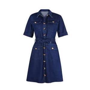 Detailed view of dark blue denim shirt dress featuring waist tie and front pockets