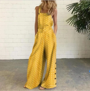 Détail d'une combinaison jaune à pois avec jambe large et boutons sur les côtés