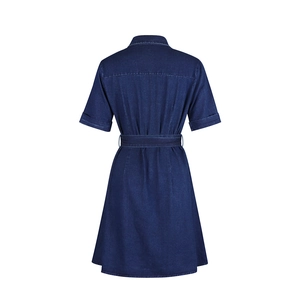 Rear view of deep blue denim dress featuring rolled short sleeves and a waist belt detail