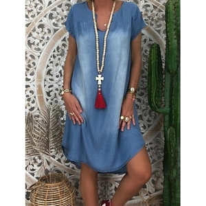 Detail of bohemian gradient denim dress with V-neckline and loose short sleeves