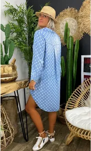 Detail of light blue shirt dress with star print and asymmetrical curved hemline