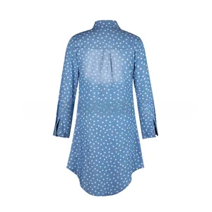 Back view of a blue star print denim shirt dress featuring a pleated back and curved hem