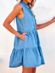 Detailed side view of light blue denim dress showing ruffled collar and tiered hemline