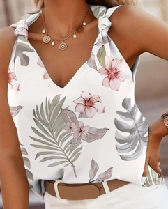 Detail of V-neck summer tank top with tropical palm leaf print and knotted shoulder straps
