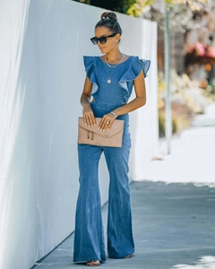 Detail showing ruffle sleeves and high-waist flared legs of the denim jumpsuit